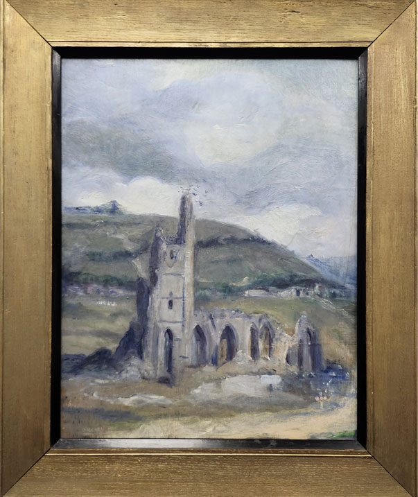 A gold-framed painting of a ruined church in the countryside.
