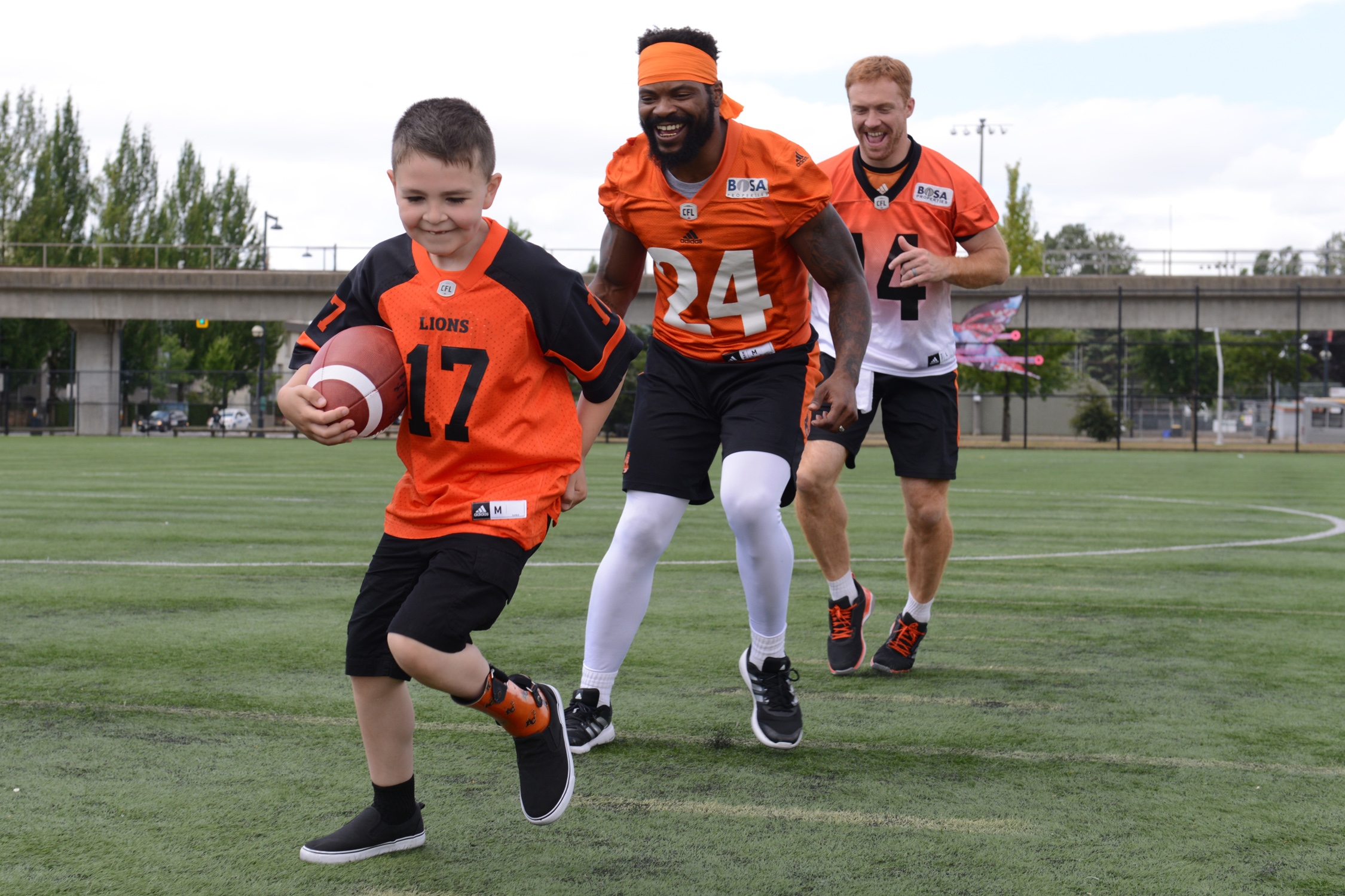 Darevin having fun on the shoot with players Travis Lulay (#14) and Jeremiah Johnson (#24).